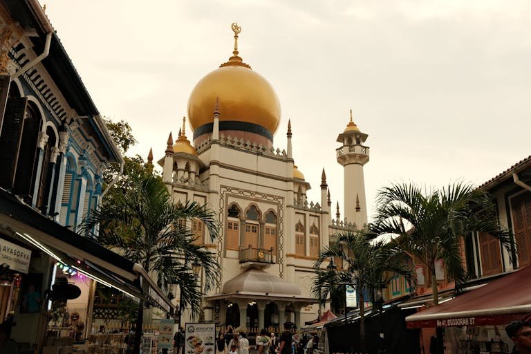 Sultan Mosque golden dome at dusk surrounded by shophouses in Singapore