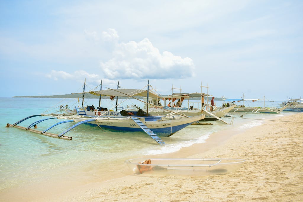 Traditional boats on a sunny Kalibo beach in the Philippines, perfect for tropical getaways.